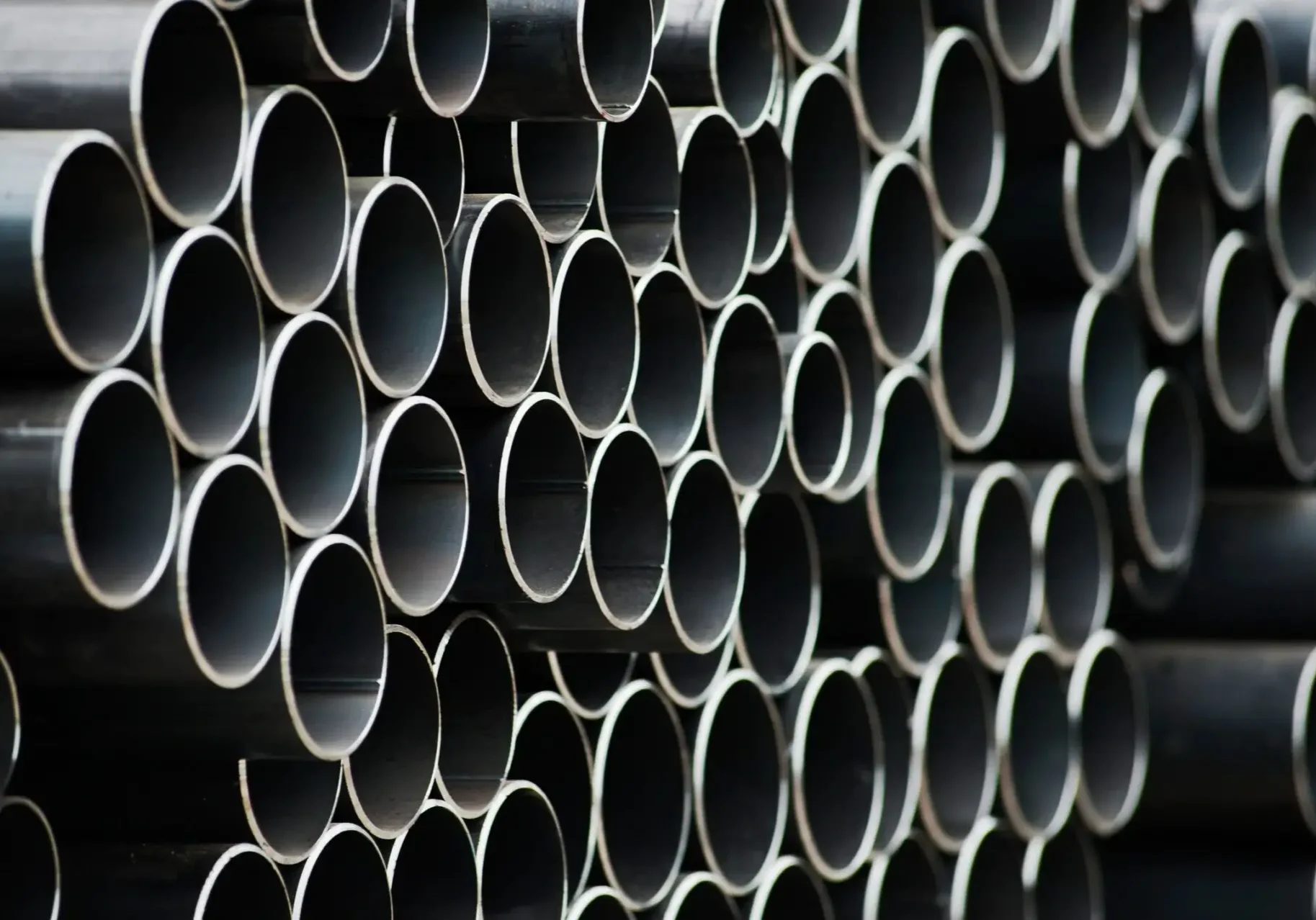 Ends of large metal tubes stacked on one another